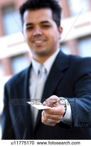 Stock Image - Businessman handing out business card. Fotosearch