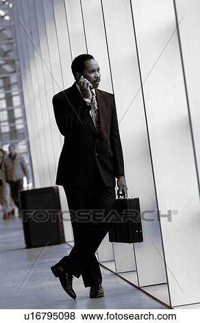 Stock Photo - Businessman on cell phone. Fotosearch