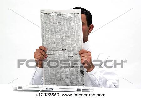 Stock Photo - Businessman reading newspaper. Fotosearch