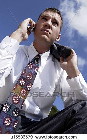 Stock Photo - Businessman talking on cell phone. Fotosearch