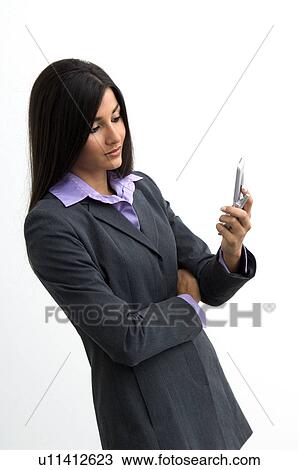 Stock Image - Businesswoman with cell phone. Fotosearch