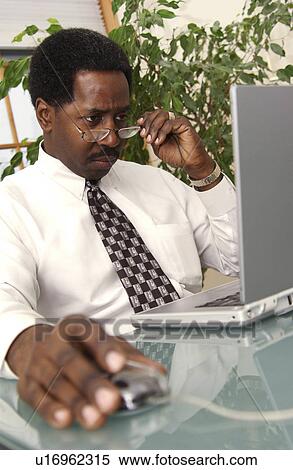 Stock Photography - Man working on laptop. Fotosearch