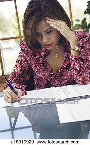Woman doing paperwork View Large Photo Image Stock Photo - Woman doing paperwork. Fotosearch