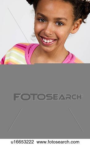 Stock Image - African American girl working on laptop. Fotosearch