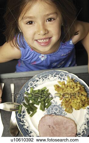 Stock Image - Asian girl with food. Fotosearch