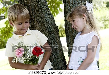 Boy giving girl flowers View Large Photo Image Stock Image - Boy giving girl flowers. Fotosearch