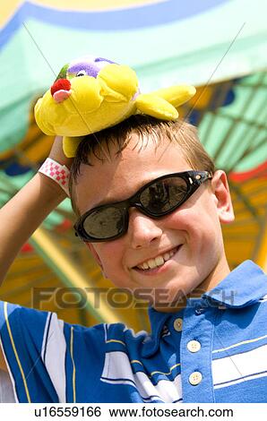 Boy holding stuffed animal at carnival View Large Photo Image Stock Photograph - Boy holding stuffed animal at carnival. Fotosearch