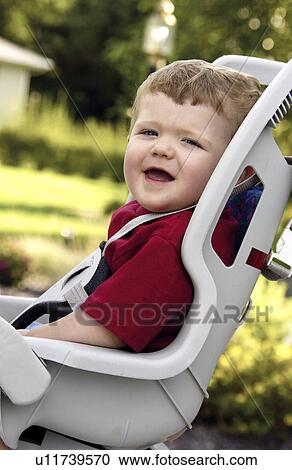 Stock Image - Boy in bike seat. Fotosearch