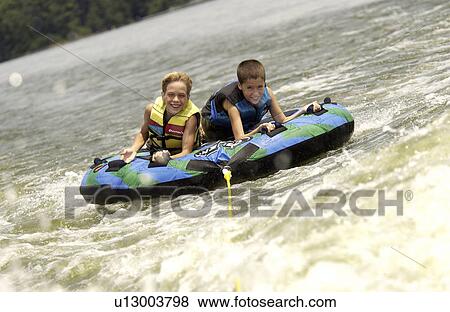 Boys on inner tube View Large Photo Image Stock Photo - Boys on inner tube. Fotosearch