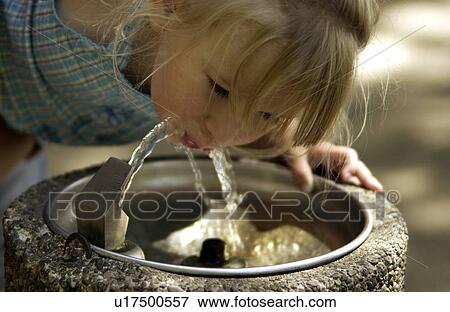 Stock Photo - Girl drinking from fountain. Fotosearch