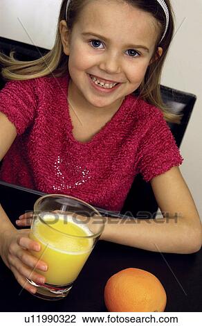 Girl drinking orange juice View Large Photo Image Stock Image - Girl drinking orange juice. Fotosearch