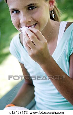 Girl eating cotton candy View Large Photo Image Stock Image - Girl eating cotton candy. Fotosearch