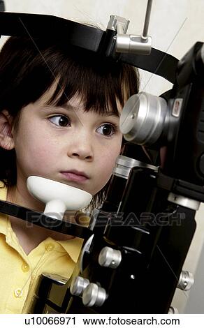 Stock Image - Girl getting vision tested. Fotosearch