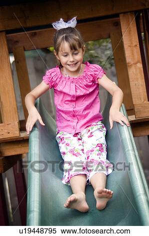 Girl going down slide View Large Photo Image Stock Photography - Girl going down slide. Fotosearch