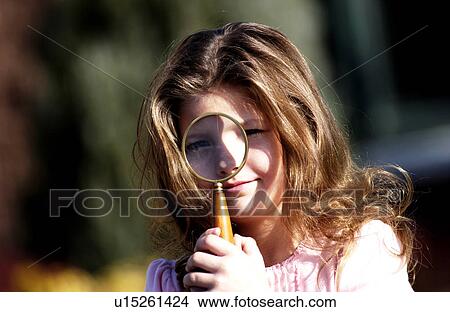 Girl looking through magnifying glass View Large Photo Image Picture - Girl looking through magnifying glass. Fotosearch