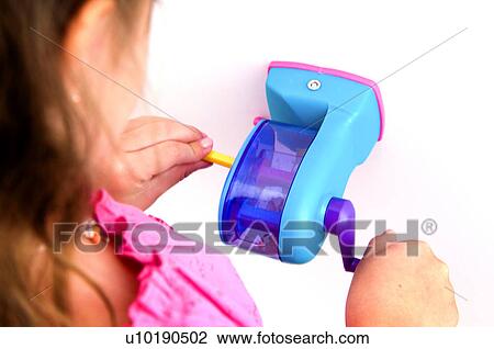 Girl sharpening pencil View Large Photo Image Stock Image - Girl sharpening pencil. Fotosearch