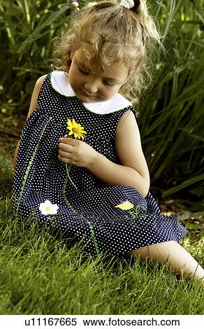 Little girl holding a flower in her hands View Large Photo Image Stock Photography - Little girl holding a flower in her hands. Fotosearch