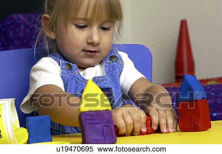 Little girl playing with molding clay View Large Photo Image Stock Photography - Little girl playing with molding clay. Fotosearch