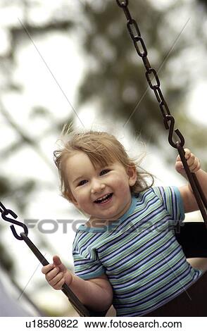 Little girl swinging View Large Photo Image Stock Image - Little girl swinging. Fotosearch