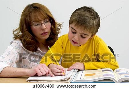 Mother or teacher helping boy with homework View Large Photo Image Stock Photo - Mother or teacher helping boy with homework. Fotosearch
