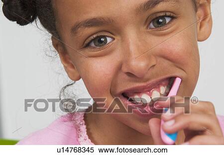 Young African American girl brushing teeth View Large Photo Image Stock Photography - Young African American girl brushing teeth. Fotosearch
