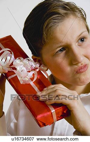 Stock Photo - Boy opening gift. Fotosearch