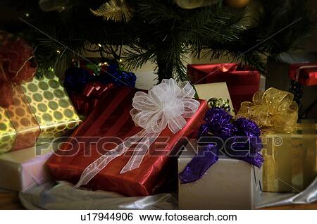 Stock Photograph - Gifts under Christmas tree. Fotosearch