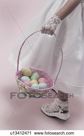 Stock Image - Girl holding Easter basket. Fotosearch