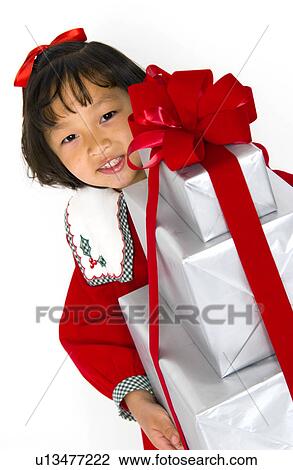 Girl with stack of Christmas presents View Large Photo Image Stock Image - Girl with stack of Christmas presents. Fotosearch