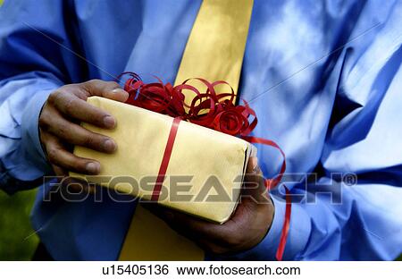 Stock Photograph - Man holding Christmas present. Fotosearch