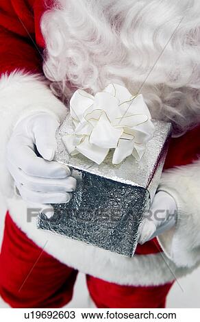 Santa holding gift View Large Photo Image Stock Image - Santa holding gift. Fotosearch