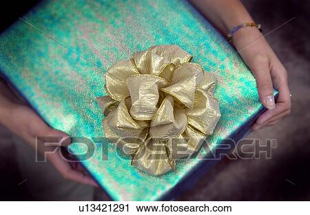 Woman holding Christmas present View Large Photo Image Stock Image - Woman holding Christmas present. Fotosearch