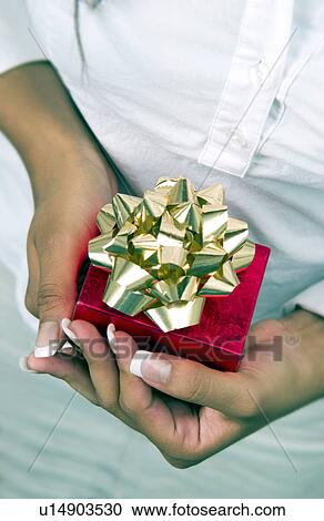 Woman holding Christmas present View Large Photo Image Stock Image - Woman holding Christmas present. Fotosearch
