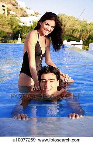 Couple in swimming pool View Large Photo Image Stock Photo - Couple in swimming pool. Fotosearch