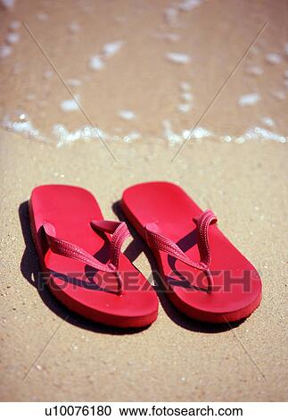 Stock Image - Flip flops on the beach. Fotosearch