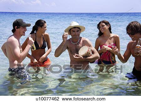 Group of friends in water having fun View Large Photo Image Stock Image - Group of friends in water having fun. Fotosearch
