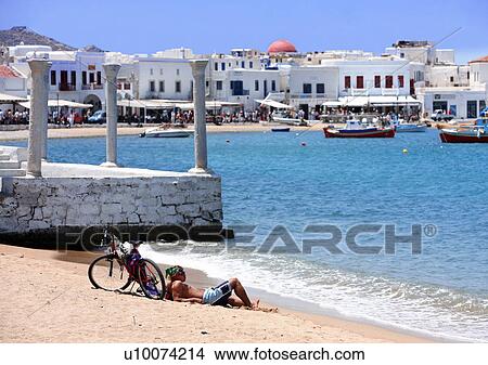Man lying on beach with bicycle View Large Photo Image Picture - Man lying on beach with bicycle. Fotosearch