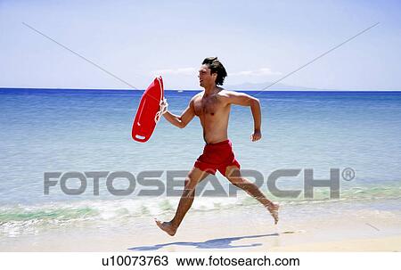 Man running on beach View Large Photo Image Stock Image - Man running on beach. Fotosearch