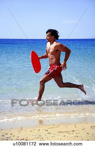 Man running on beach View Large Photo Image Stock Image - Man running on beach. Fotosearch