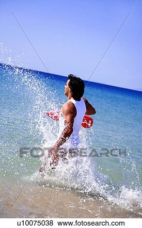Man splashing through water View Large Photo Image Stock Photo - Man splashing through water. Fotosearch