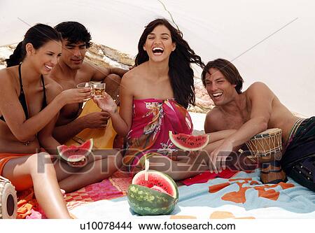 Two couples on beach having fun View Large Photo Image Picture - Two couples on beach having fun. Fotosearch