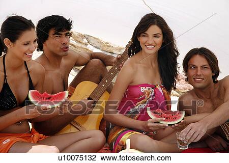 Two couples on beach having fun View Large Photo Image Stock Image - Two couples on beach having fun. Fotosearch