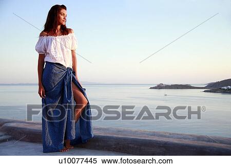 Stock Photography - Woman on terrace with a view. Fotosearch