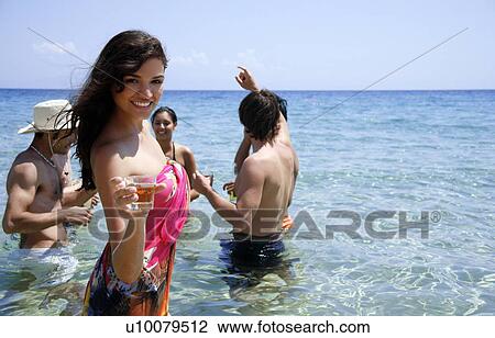 Woman with group of friends in the water View Large Photo Image Stock Image - Woman with group of friends in the water. Fotosearch