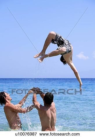 Young men playing around in the water View Large Photo Image Stock Photo - Young men playing around in the water. Fotosearch