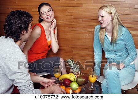 Stock Image - Friends having a refreshment after a spa treatment. Fotosearch