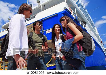 Stock Photography - Group of friends in front of ferry. Fotosearch