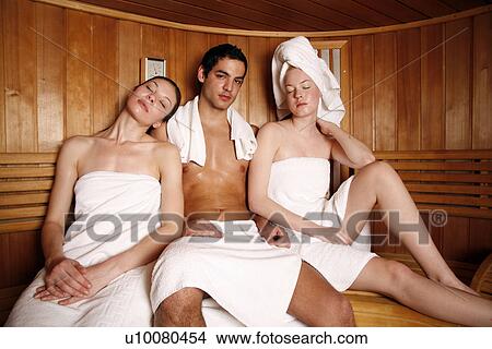 Man with two young women enjoying a sauna View Large Photo Image Picture - Man with two young women enjoying a sauna. Fotosearch