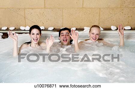 One man with two women in jacuzzi at a spa View Large Photo Image Stock Image - One man with two women in jacuzzi at a spa. Fotosearch