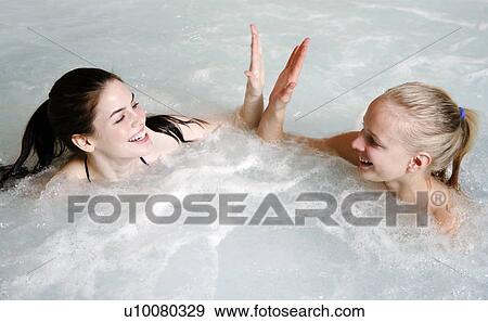 Two young woman in jacuzzi at a spa View Large Photo Image Stock Photo - Two young woman in jacuzzi at a spa. Fotosearch